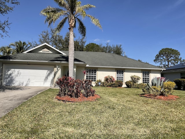 ranch-style home featuring a garage and a front lawn