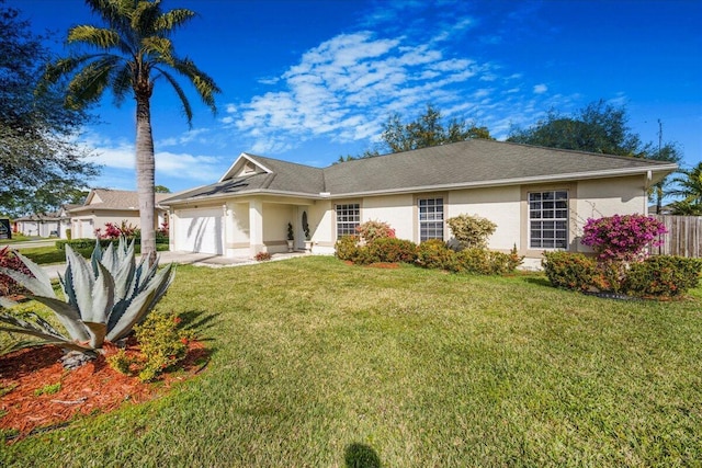 view of front of house with a garage and a front lawn