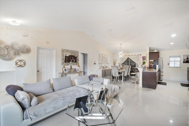 living room featuring a notable chandelier and vaulted ceiling