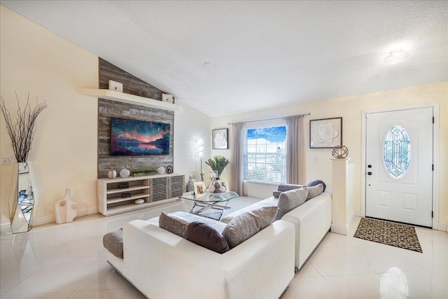 living room featuring light tile patterned flooring, vaulted ceiling, and a textured ceiling