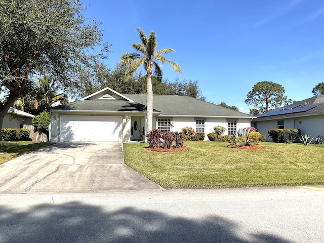 ranch-style home with a garage and a front yard