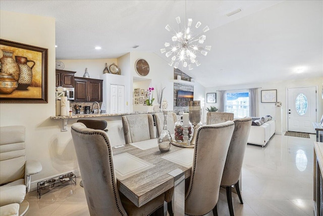 dining area featuring lofted ceiling and a chandelier