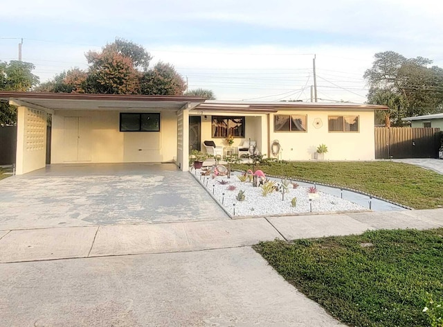 ranch-style house with a carport and a front yard