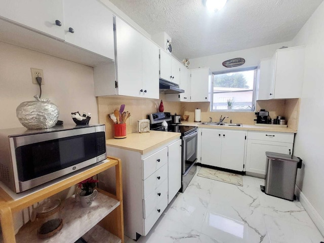 kitchen featuring white cabinetry, sink, a textured ceiling, and appliances with stainless steel finishes