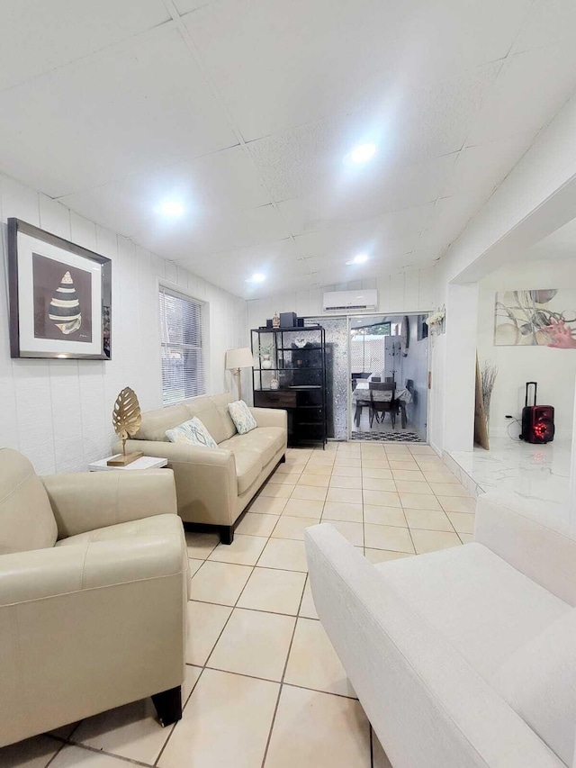 tiled living room featuring a wall unit AC