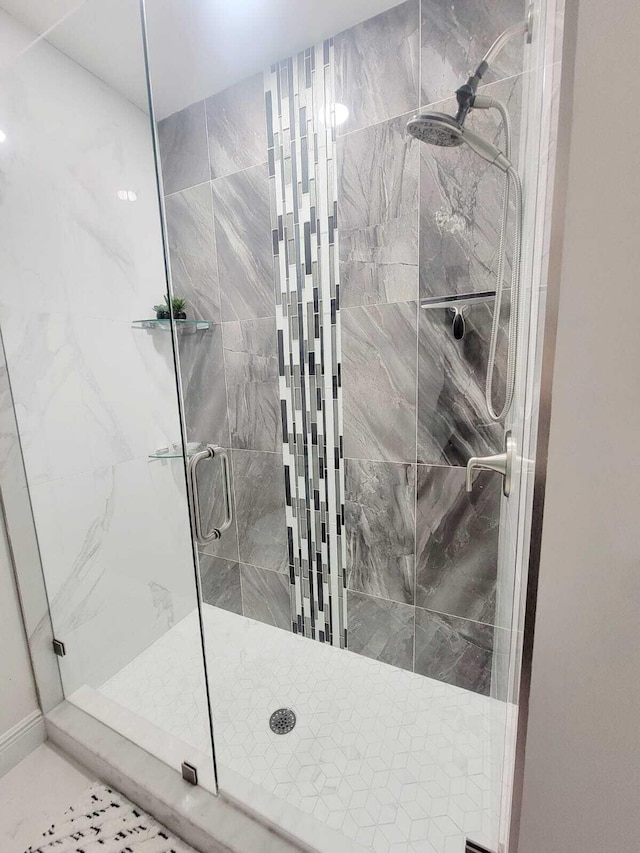 bathroom with a shower with door