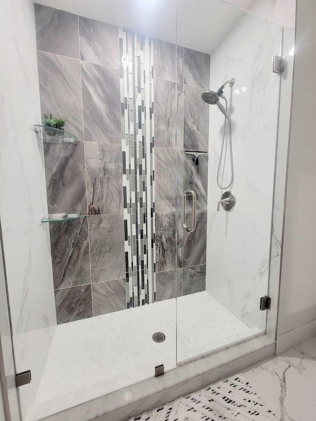 bathroom with a shower with shower door