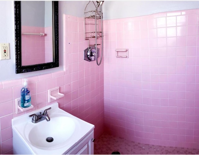 bathroom with vanity and tile walls