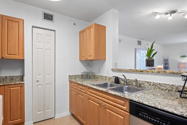 kitchen with dishwasher, light stone countertops, sink, and light tile patterned floors