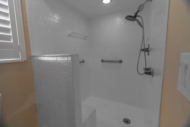 bathroom with a tile shower