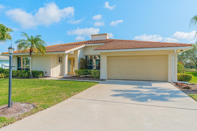 view of front of house with a garage and a front yard