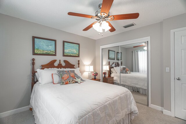 bedroom with light colored carpet, visible vents, a closet, and baseboards