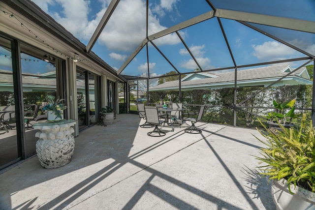 view of patio / terrace with glass enclosure and outdoor dining space