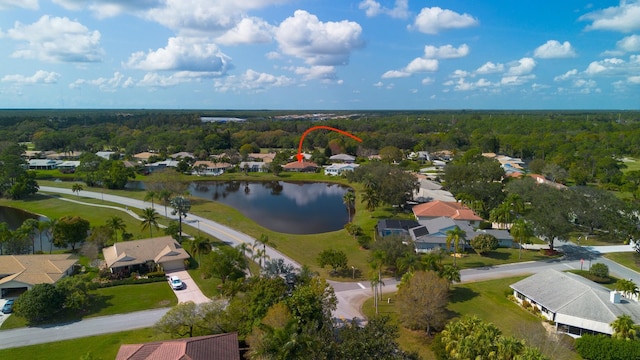 aerial view featuring a forest view, a water view, and a residential view