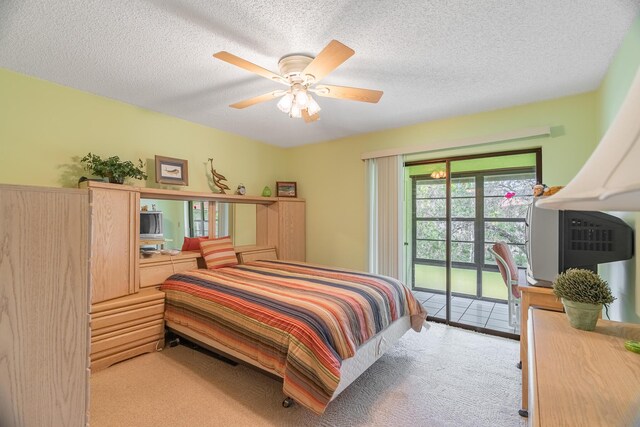 carpeted bedroom featuring a textured ceiling and ceiling fan