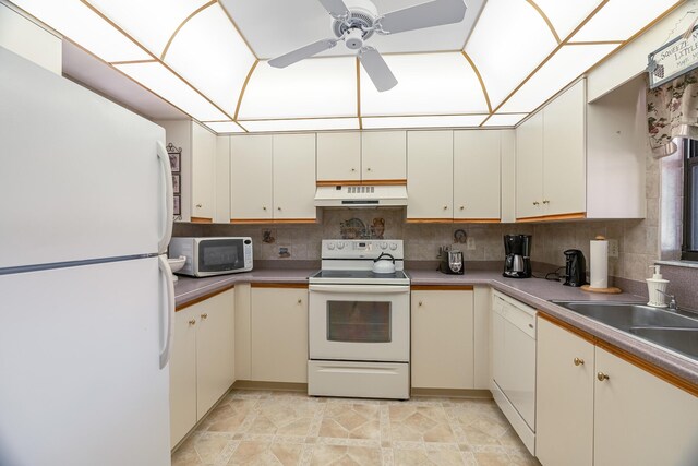 kitchen featuring sink, dishwasher, white cabinetry, and backsplash