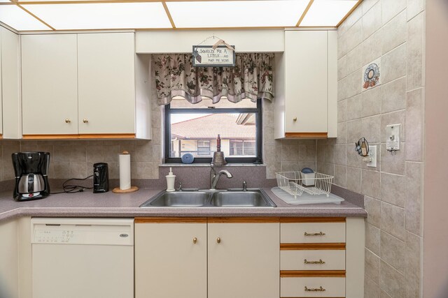 kitchen with white appliances, exhaust hood, backsplash, and cream cabinets