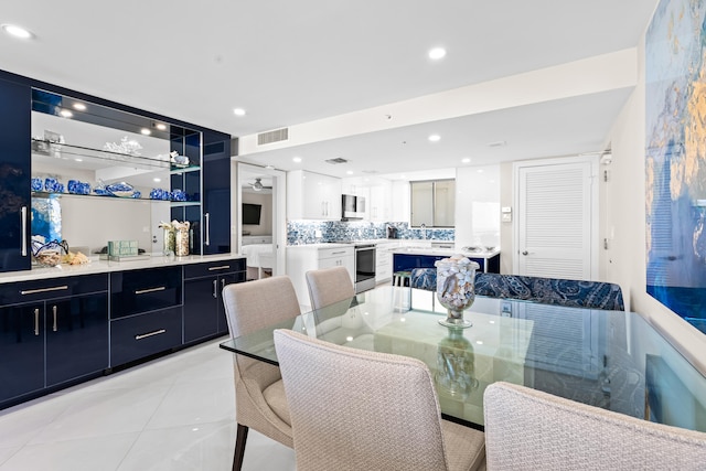 tiled dining area featuring sink