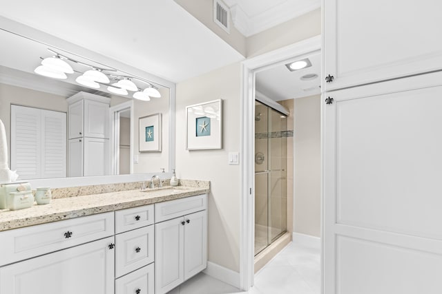 bathroom with tile patterned flooring, vanity, and a shower with shower door