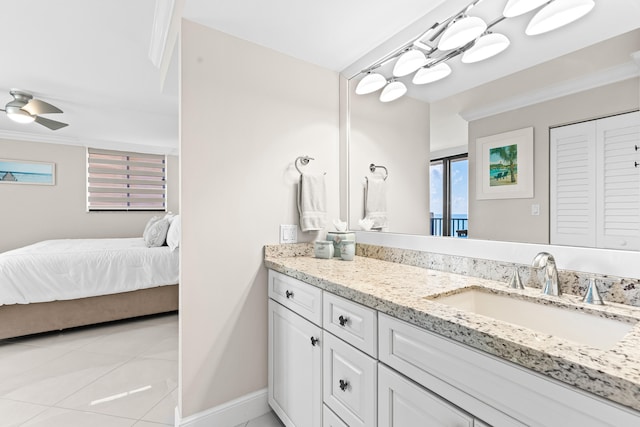 bathroom featuring tile patterned flooring, ornamental molding, vanity, and ceiling fan