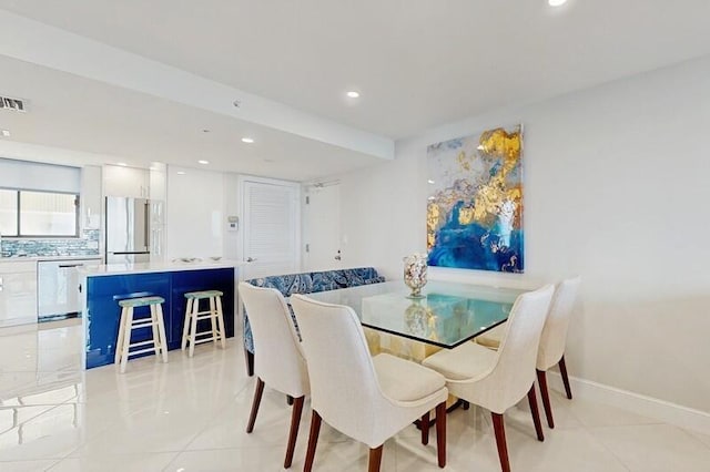 dining area featuring light tile patterned flooring and sink