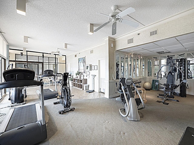 workout area with light carpet, crown molding, a textured ceiling, and ceiling fan