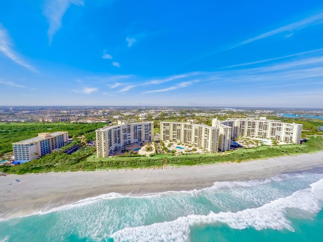 birds eye view of property with a water view and a view of the beach