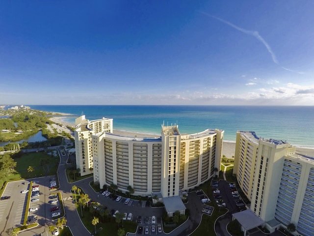 birds eye view of property featuring a beach view and a water view