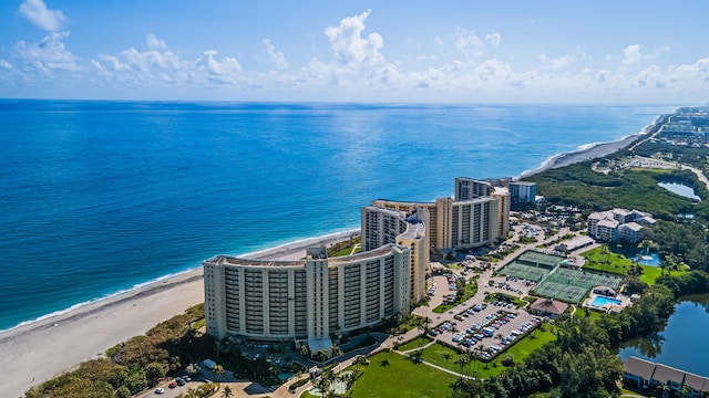 birds eye view of property featuring a water view and a beach view