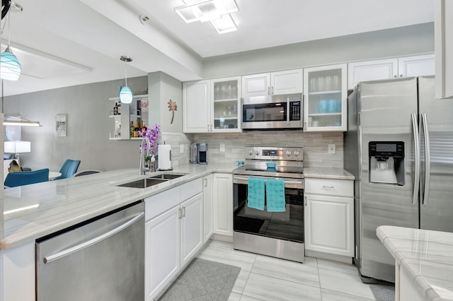 kitchen with white cabinetry, appliances with stainless steel finishes, sink, and pendant lighting