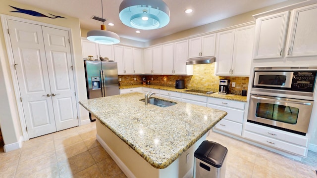 kitchen with stainless steel appliances, hanging light fixtures, sink, and white cabinets