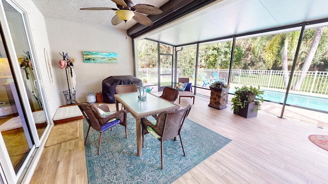 sunroom featuring ceiling fan