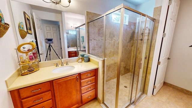 bathroom featuring tile patterned flooring, vanity, and walk in shower