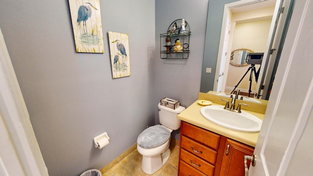 bathroom with vanity, tile patterned flooring, and toilet