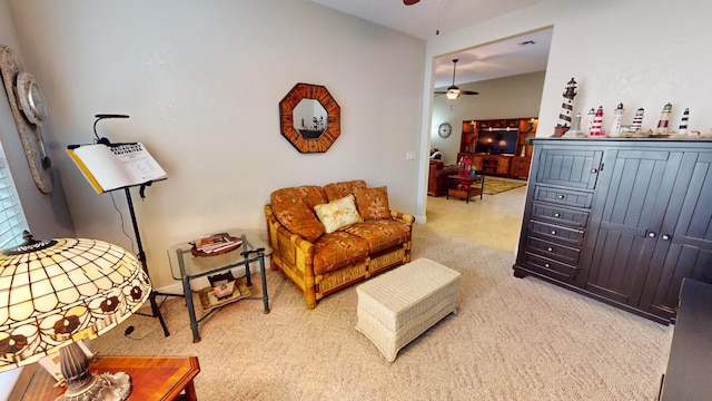 sitting room featuring ceiling fan, vaulted ceiling, and carpet