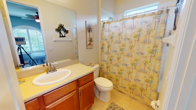 bathroom featuring vanity, a wealth of natural light, tile patterned floors, and toilet