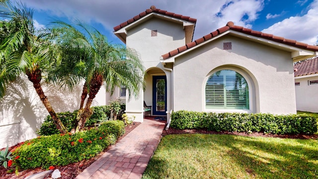 mediterranean / spanish home with a front yard