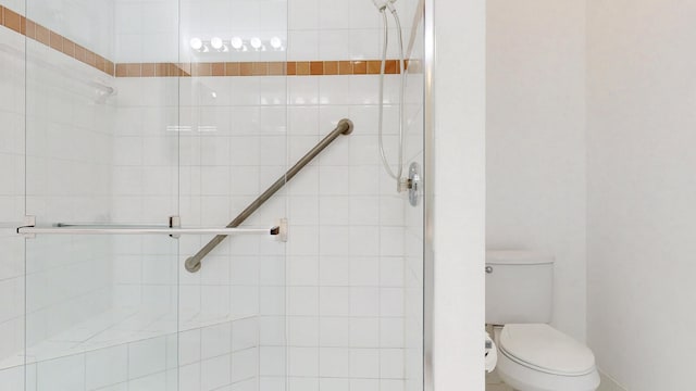 full bathroom with a shower stall and toilet