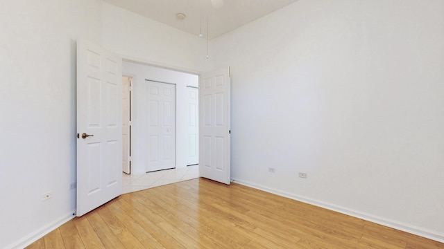 interior space with baseboards and light wood-type flooring