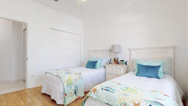 bedroom featuring wood finished floors, a closet, and baseboards