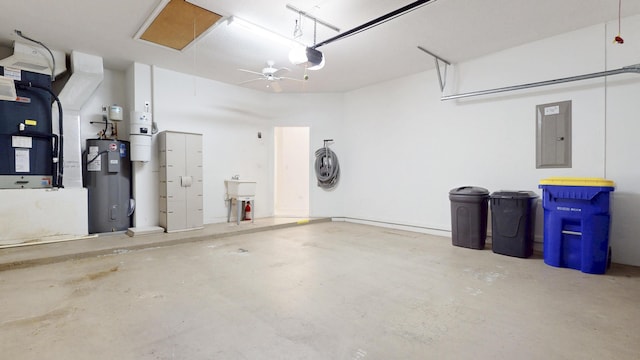 garage featuring electric panel, heating unit, electric water heater, and a garage door opener