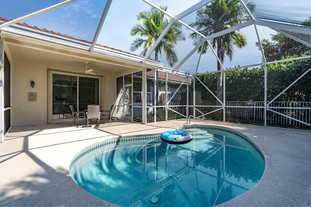 view of pool with a ceiling fan, a lanai, a patio area, and a fenced in pool