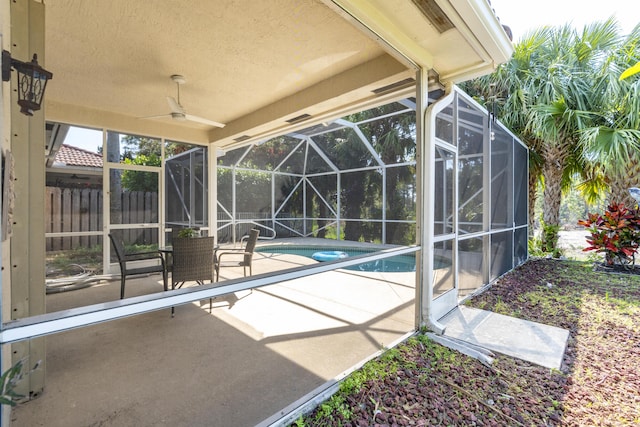 view of pool with a patio, a fenced in pool, fence, ceiling fan, and a lanai