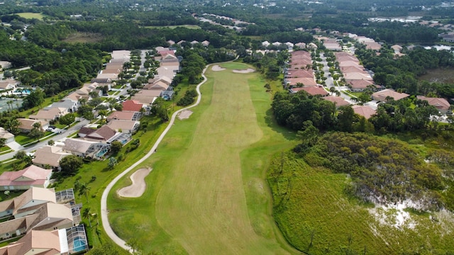 drone / aerial view featuring view of golf course and a residential view