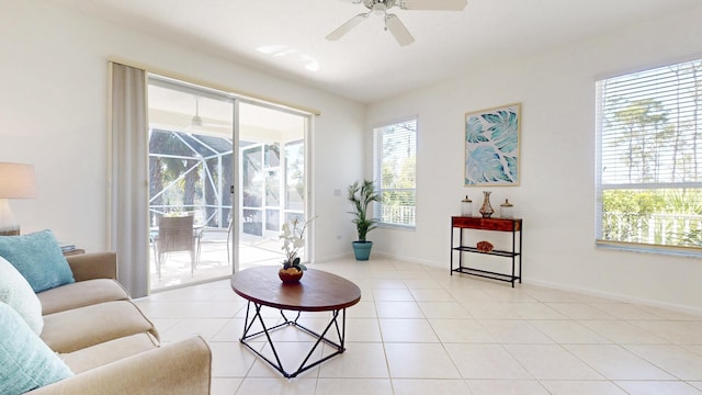 living room featuring baseboards, light tile patterned flooring, and a sunroom