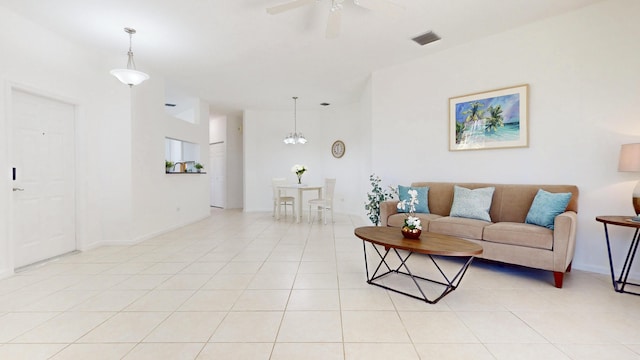 living area with light tile patterned floors, visible vents, and ceiling fan