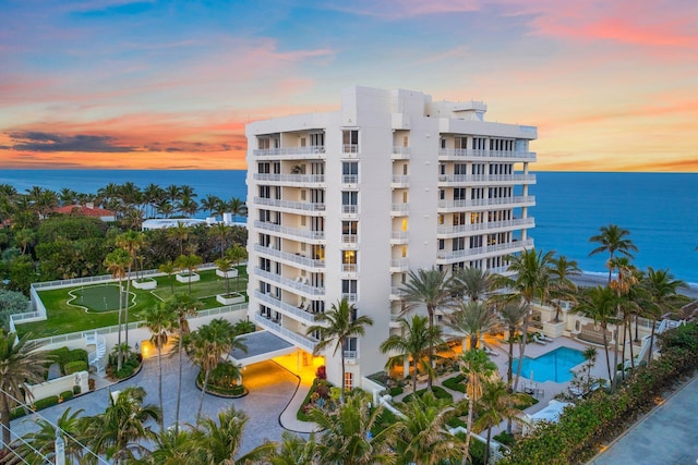 outdoor building at dusk featuring a water view