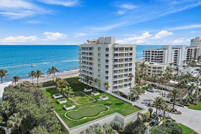 birds eye view of property featuring a water view and a view of the beach