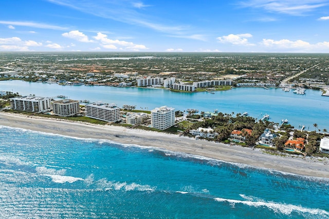 birds eye view of property featuring a beach view and a water view