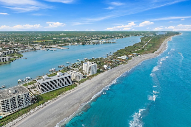 birds eye view of property with a water view and a view of the beach